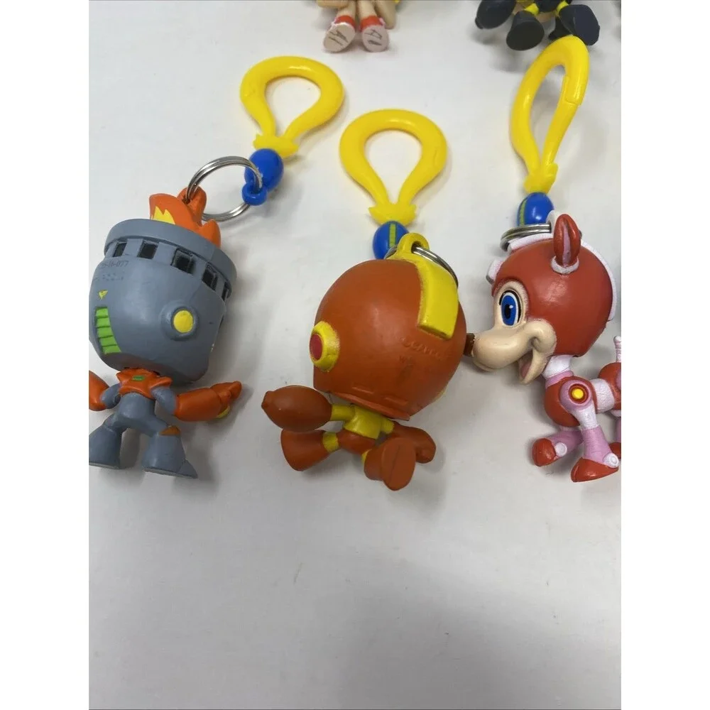 lot of 9 CAPCOM MEGA MAN BACKPACK HANGERS METALLIC FIRE MAN JUST TOYS INTL.